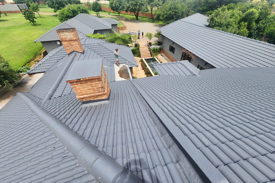 Freshly painted charcoal concrete tile roof on a large residential home